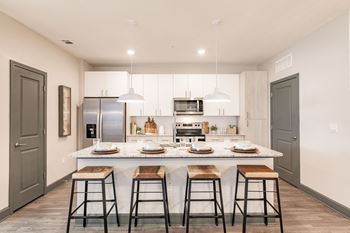 Fitted kitchen with island dining